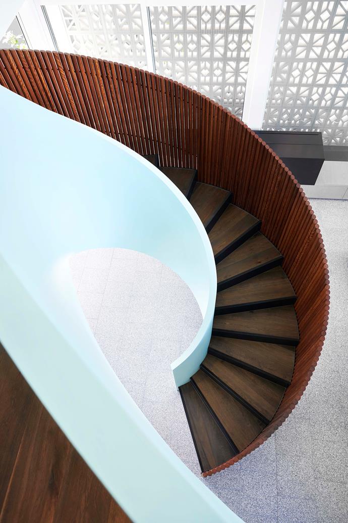 Timber battens frame the spiralling internal staircase. The robust terrazzo flooring is forgiving of sandy footprints.