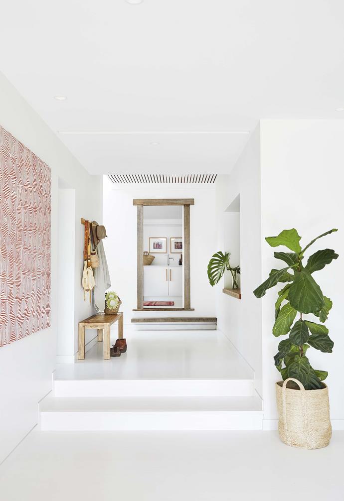 **Hallway** Timber detailing around the laundry door by [Bernie & Co](https://www.instagram.com/bernieandco/|target="_blank"|rel="nofollow") adds warmth to the all-white scheme. A [Tigmi Trading](https://tigmitrading.com/|target="_blank"|rel="nofollow") bench seat and locally handcrafted Buffalo Girl bags on the coat rack add visual interest. Basket, [The Dharma Door](https://thedharmadoor.com.au/|target="_blank"|rel="nofollow").