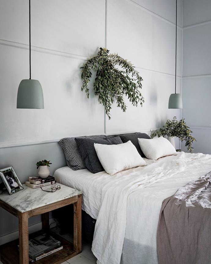 Foliage from olive trees decorate the main bedroom, which features [Mud Australia](https://mudaustralia.com/|target="_blank"|rel="nofollow") lamps.
