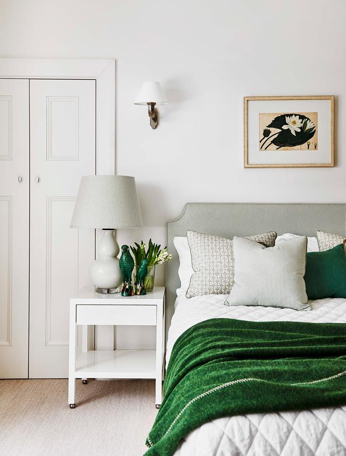 In another bedroom, parrots and dark green pillow from Brownlow Designs, and bedside table and lamp from Bragg & Co. Custom bedspread by Adelaide Bragg in 'Rosetti' fabric from Grant Dorman.