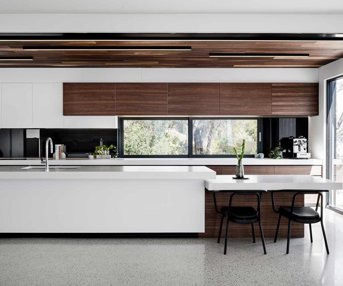 **Kitchen** The [kitchen space](https://www.homestolove.com.au/kitchens-with-clever-design-ideas-to-steal-6962|target="_blank") makes the most of the home's material palette, with [white benchtops](https://www.homestolove.com.au/kitchen-benchtop-guide-19237|target="_blank") complementing spotted gum cabinetry and the polished concrete floor. The generous [kitchen island](https://www.homestolove.com.au/kitchen-inspiration-13-of-the-best-island-benches-17943|target="_blank") makes the space perfect for entertaining and connects seamlessly with the living and dining zones. The windows in the [splashback](https://www.homestolove.com.au/12-splashback-ideas-that-arent-white-subway-tiles-17258|target="_blank") allow additional natural light to enter the space.