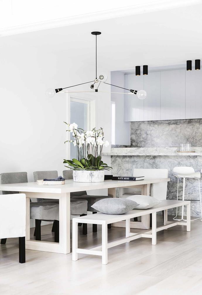 Following a similarly serene and subdued palette of blond timber, soft greys, powder blues and black accents, the kitchen in [the home of bellaMumma's Nikki Yazxhi](https://www.homestolove.com.au/bellamumma-nikki-yazxhi-home-tour-16880|target="_blank") blends seamlessly into the dining room, which tiers down via two steps.