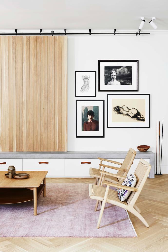 In the living room, a sliding timber panel keeps the television out of sight when not in use. Hans J Wegner 'CH25 Easy Chairs' by [Carl Hansen & Søn](https://www.carlhansen.com/en|target="_blank"|rel="nofollow").