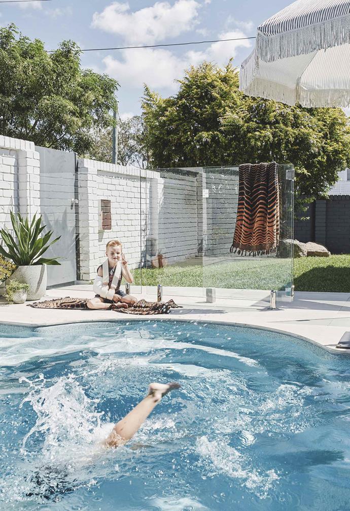 **Pool area** With boisterous boys to keep an eye on, glass fencing gives the yard a stylish, safety-conscious update. A 'Natural Instinct' umbrella from Sunday Supply Co provides shade, with towels from Kip&Co.