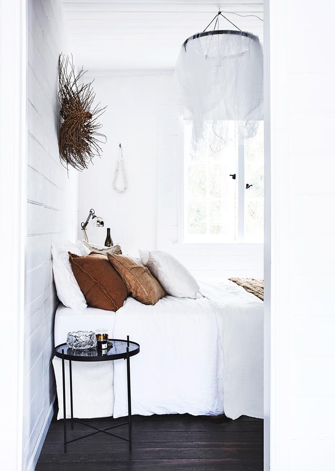 Breathable linen bedding is a luxury on hot summer nights. These Hale Mercantile Co linen pillowcases and sheets are from Camargue. Lisa made the white net lights, and the glass bowl was a vintage find.