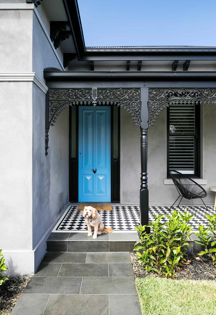 The couple focused on aiming to, "reinstate as many Victorian features as possible in the front part of the house, by bringing back large profile skirts, arcs, cornices, ceiling roses, On the exterior facade we added a bullnose veranda, lacework, window mouldings, timber sash windows, and more."<br><br>**Front step** The playful black and white patterned tiles work seamlessly with the monochrome [exterior palette](https://www.homestolove.com.au/12-exterior-colour-palettes-to-inspire-your-home-renovation-17194|target="_blank"|rel="nofollow"). A seating area on the porch provides the perfect lookout for when children play in the front yard.