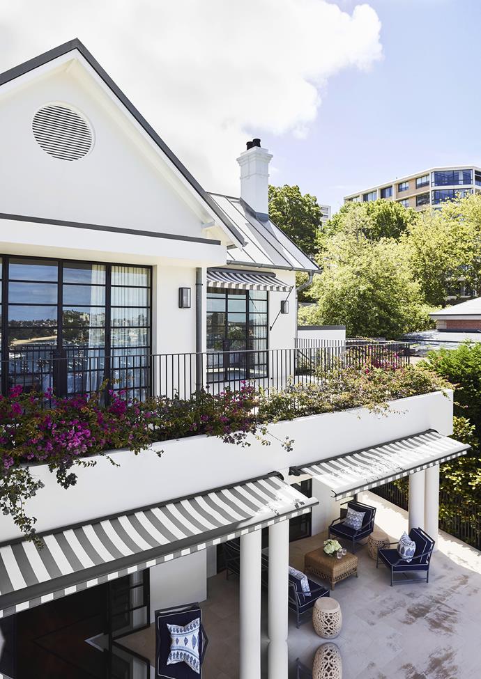 Black and white striped awnings perfectly match the external colour scheme of this luxurious Sydney home. *Photo: Anson Smart / bauersyndication.com.au*