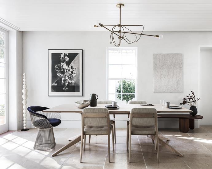 Dining table by Matthew Hilton with 'Capo' chairs by Neri & Hu, all from Spence & Lyda. Alessandro Di Sarno water jug from Planet. Ceramic dinner plates from Montmartre Concept Store. Tom Dixon 'Bash' silver bowl from De De Ce. Artwork by Heidi Yardley.