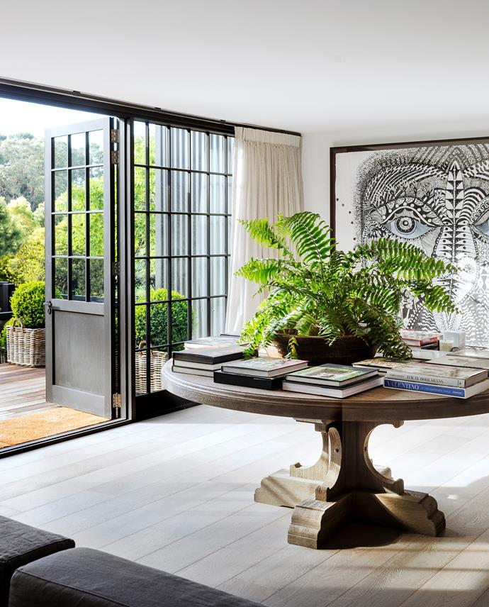 Between the guest quarters and family room is this transitional area leading out to the garden. Round table, Restoration Hardware (US). Artwork by Joshua Yeldham.