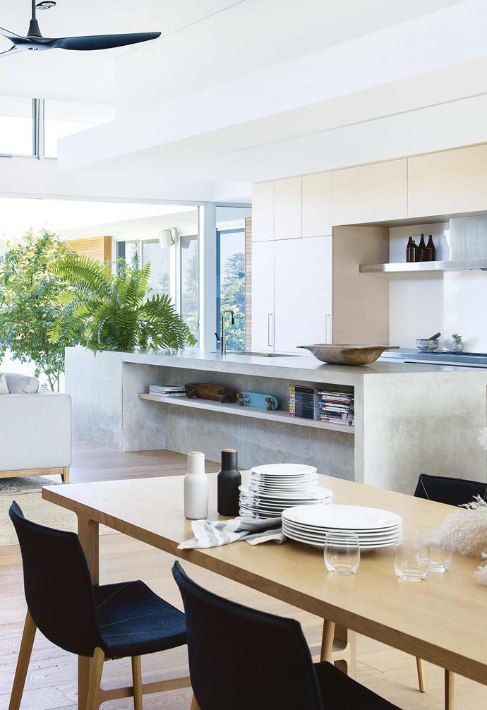 **Versatility** This custom concrete kitchen island in this [bright and airy Perth home](https://www.homestolove.com.au/tour-this-bright-and-airy-perth-home-17078|target="_blank"|rel="nofollow") features a built-in shelf for additional storage and display. *Styling: Lisa Quinn-Schofield | Photography: Jody D'Arcy*.