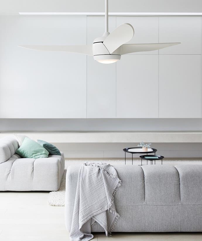 This integrating ceiling fan lamp creates bright lighting, perfectly matching the simple Scandi-style of this open plan living room. *Image / supplied*