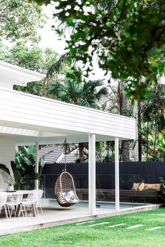 A cane hanging chair from Byron Bay Hanging Chairs is a favourite spot to enjoy the lush garden views from this [coastal weatherboard home](https://www.homestolove.com.au/a-coastal-weatherboard-home-byron-bay-19669|target="_blank") in Byron Bay.