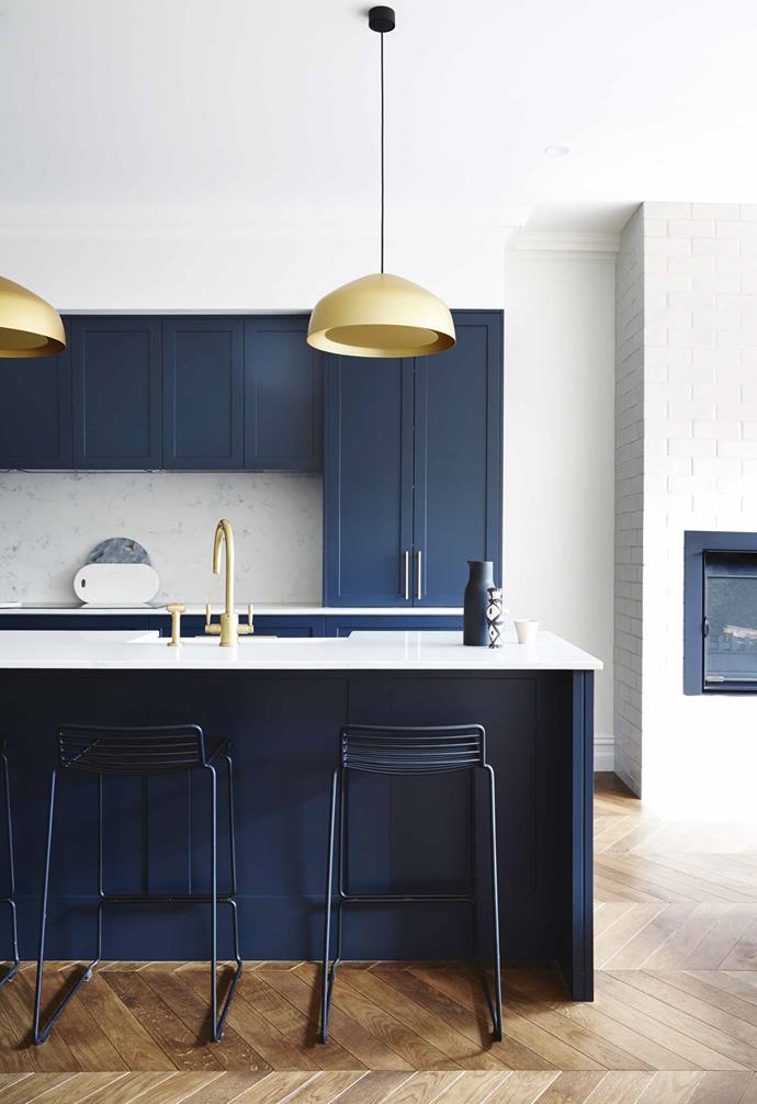 **Something blue** Blue is a bold and contemporary look in this renovated [Edwardian home](https://www.homestolove.com.au/modern-edwardian-semi-renovation-18524|target="_blank") with the shaker style cabinet fronts softening up the vibrant look. Elegant Ross Gardam pendant lights make a dramatic statement against the navy and is paired with a gold tap and mixer. <br><br>*Design: [Sarah Harris Design](http://sarahharrisdesign.com.au/|target="_blank"|rel="nofollow") | Styling: Heather Nette King | Photography: Armelle Habib*.