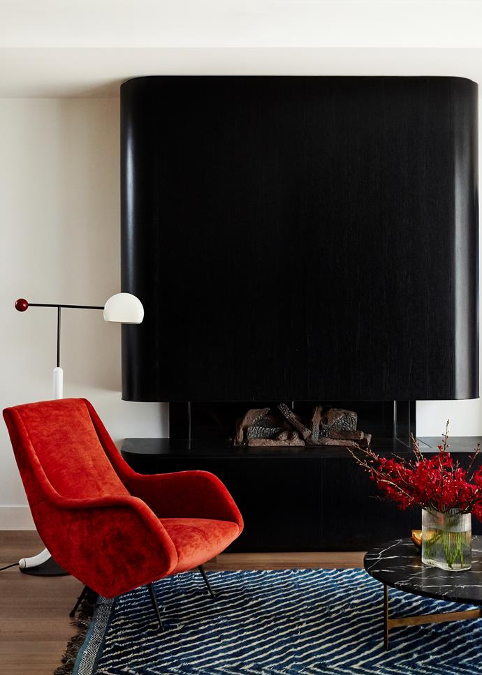 The living room of this South Yarra pad designed by Full of Grace Interiors features an Aldo Morbelli armchair and chrome half-moon table lamp, both from Atlas Gallery. *Photograph*: Fiona Storey. From *Belle* February/March 2019.