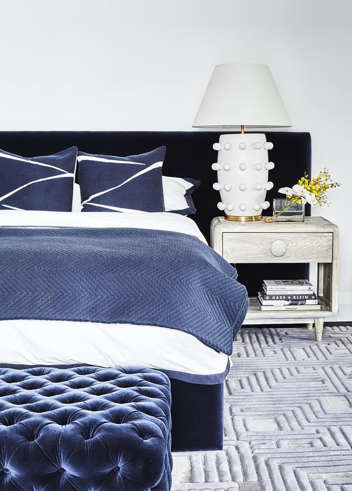 'Mirabelle' headboard from Heatherly Designs, Kelly Wearstler 'Linden' table lamp on a 'Westover' nightstand from Max Sparrow. Tufted ottoman from Arthur G. Rug from RC+D.