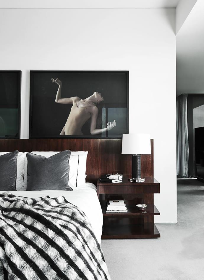 In the master bedroom, photographs from Justin Ridler's 'SOMA 4th Movement' series above a custom bed and crocodile leather lamps from Ralph Lauren Home, with a throw from Fanuli.