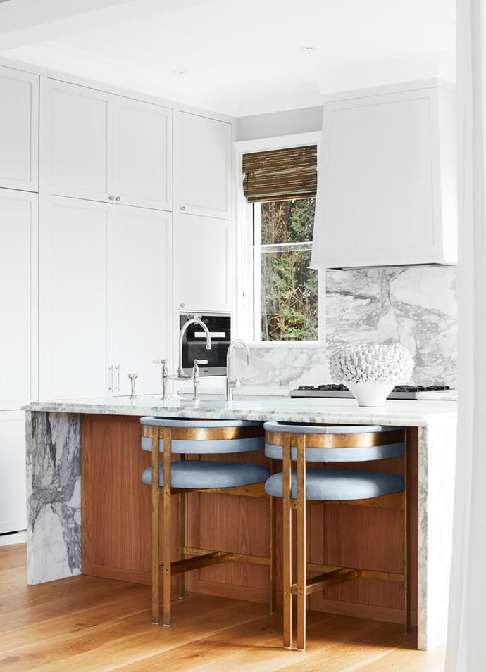 The kitchen bench and splashback is in Arabescato marble from Harmony Stone Gallery. Tap from The English Tapware Company. Custom bar stools in leather and brass.