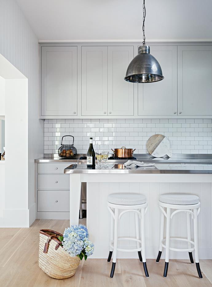 In the kitchen, an industrial style pendant lamp from Magins hangs over Thonet stools and [shaker style cabinets](https://www.homestolove.com.au/kitchen-cabinet-door-styles-7021|target="_blank").