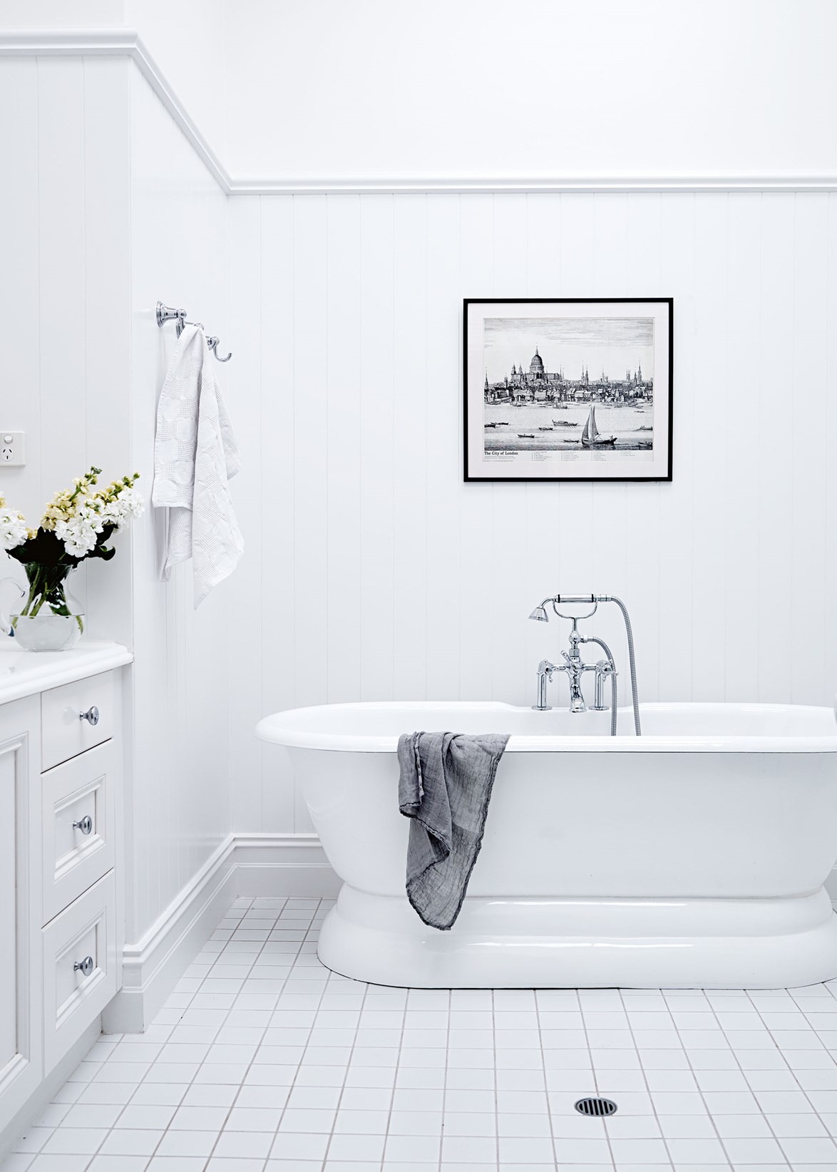 White is a key ingredient in the transformation of [this 19th-century stone homestead](https://www.homestolove.com.au/classic-contemporary-homestead-13411|target="_blank") and the bathroom is no exception. Keeping things simple with chrome accessories and a black and white art print above it, the bath takes centre stage.
