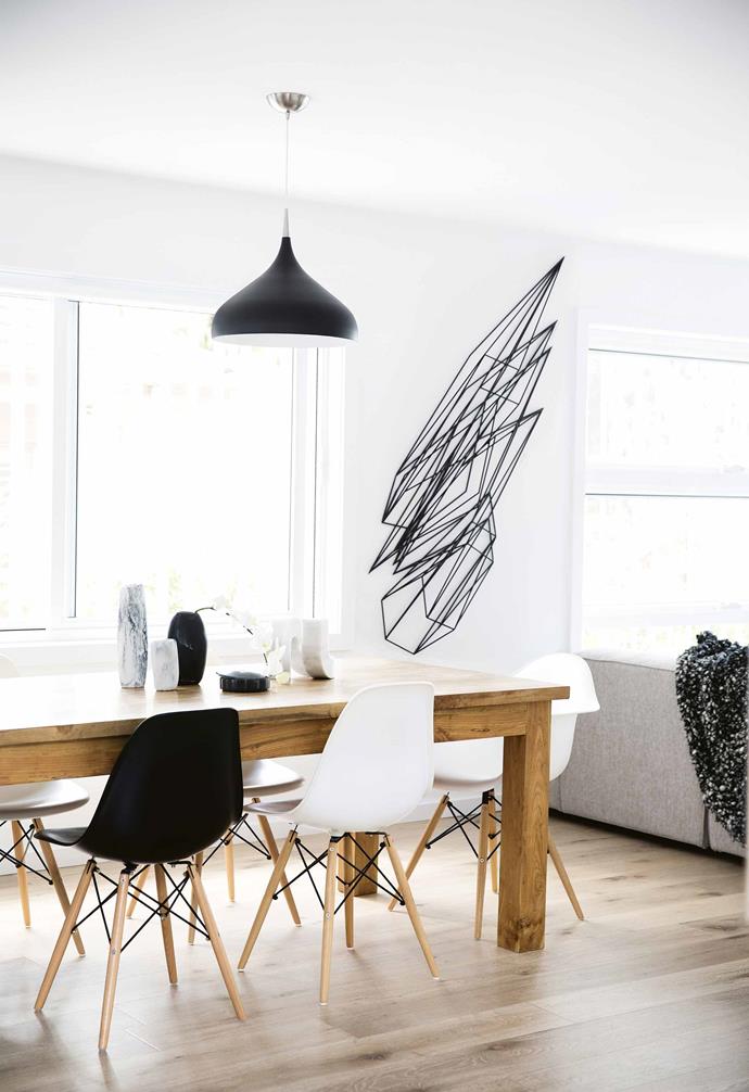 This plays out with white walls, bold lighting and other star furniture items in black. The [white kitchen](https://www.homestolove.com.au/best-white-kitchens-17040|target="_blank") has also been broken up with dollops of black. "As we were building it we thought it might look very stark, so we decided instead to go for black cabinetry for the pantry and internal laundry," says Sophie. It's now Dean's favourite part of the house. "I love the black on the cupboards. It makes that working area disappear," he says.<br><br>**Artwork** A commissioned sculpture by artist [Dion Horstmans](http://dionhorstmans.com/|target="_blank"|rel="nofollow") hangs in the centre of the living area as a design muse. "It's like a lightning bolt; it's incredible," says Sophie. "We knew that it was going to be one of the major features, so we decided to keep everything very white and go with elements of matte black throughout."