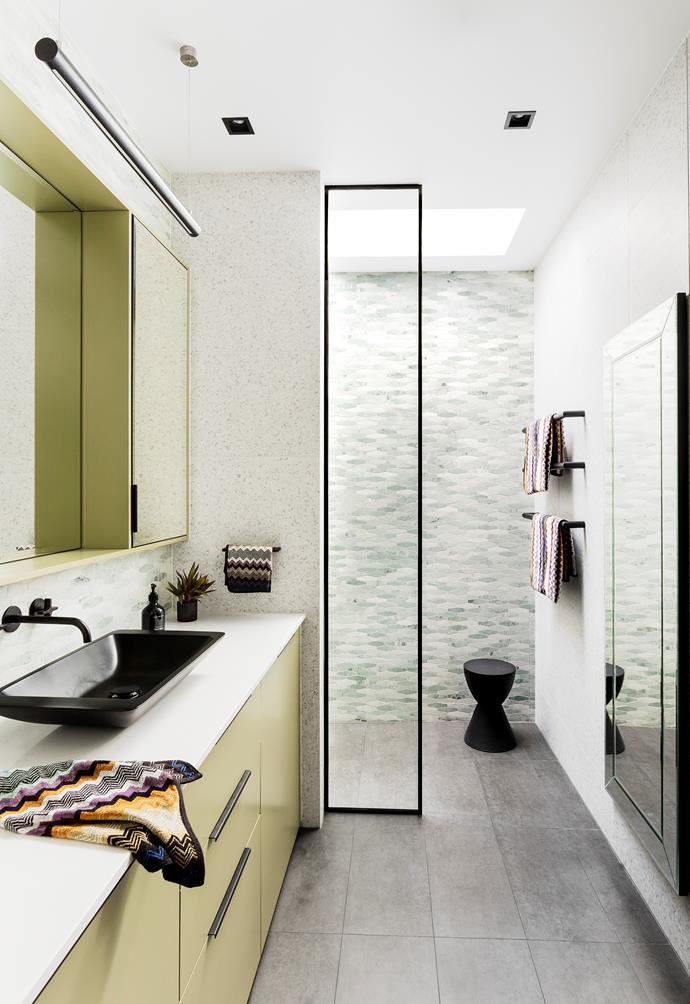 Olive green is the hero of this bathroom by Peter Schaad; for wet areas it is important to select floor tiles that are highly slip-resistant – these are charcoal matt porcelain tiles from Byzantine Design. *Photo*: Martina Gemmola