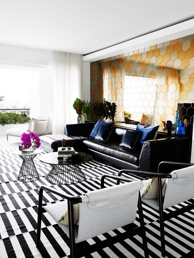 Interior designer Michelle Macarounas coaxed this dilapidated Art Deco property back to a modern design. Michelle installed the wall art of mixed hexagonal tiles to bring the ocean view inside. The striped rug is from Hali. *Photograph*: Prue Ruscoe. | *Belle*