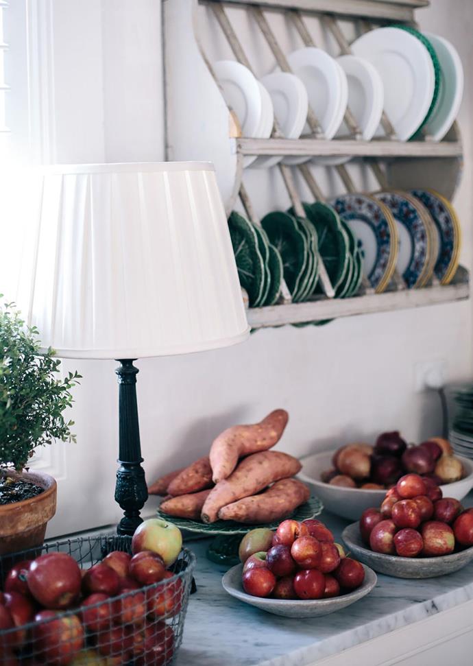 Melissa Penfold piles shiny red apples and kumera in bowls and baskets with plates lined in wall racks at her NSW southern highlands country house.