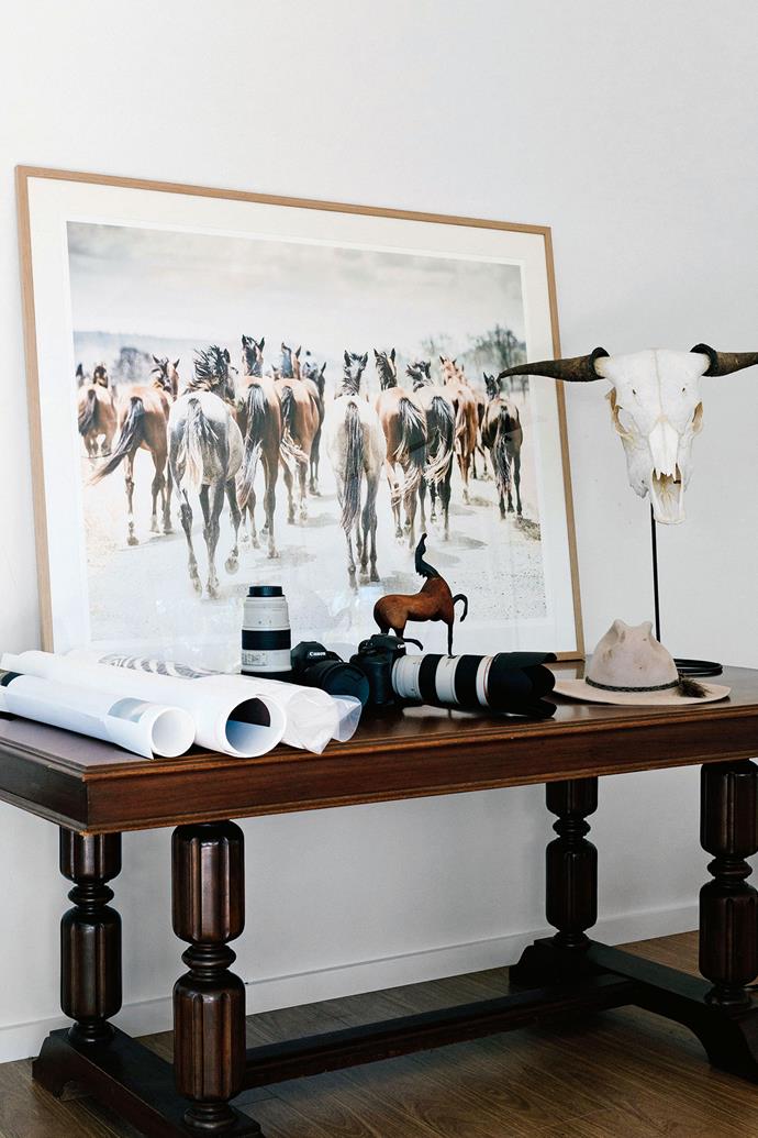 A framed coloured print entitled Finch Farm Horse Tails sits on a desk in Katie's studio alongside cameras. Katie often [works at the farm](https://www.homestolove.com.au/the-farm-byron-bay-7002|target="_blank") — feeding, mucking out and helping during the breeding season. "I love watching the foals grow into weanlings, then yearlings and seeing their progression."