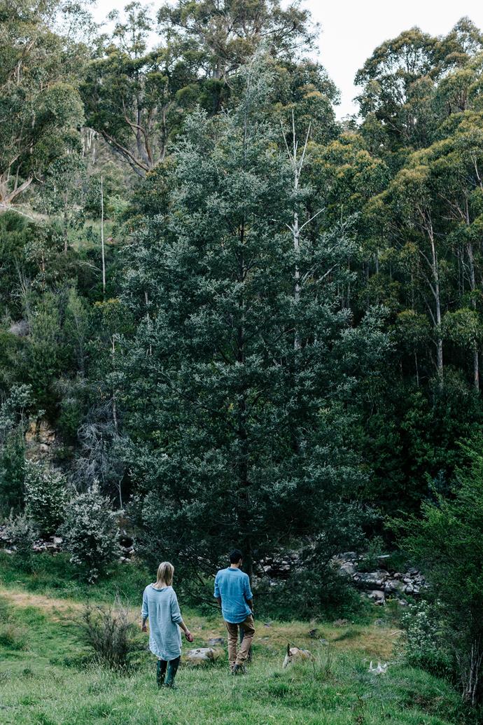 Laura and Boz going for a wander through the property's [rambling wild garden](https://www.homestolove.com.au/a-rural-property-in-central-victoria-6355|target="_blank"). Their favourite time is when they're in the garden, pottering about with their animals. "I like to sit on the deck and talk to the chickens," says Laura. "We'll be here forever — even though, perhaps, I should never say never."