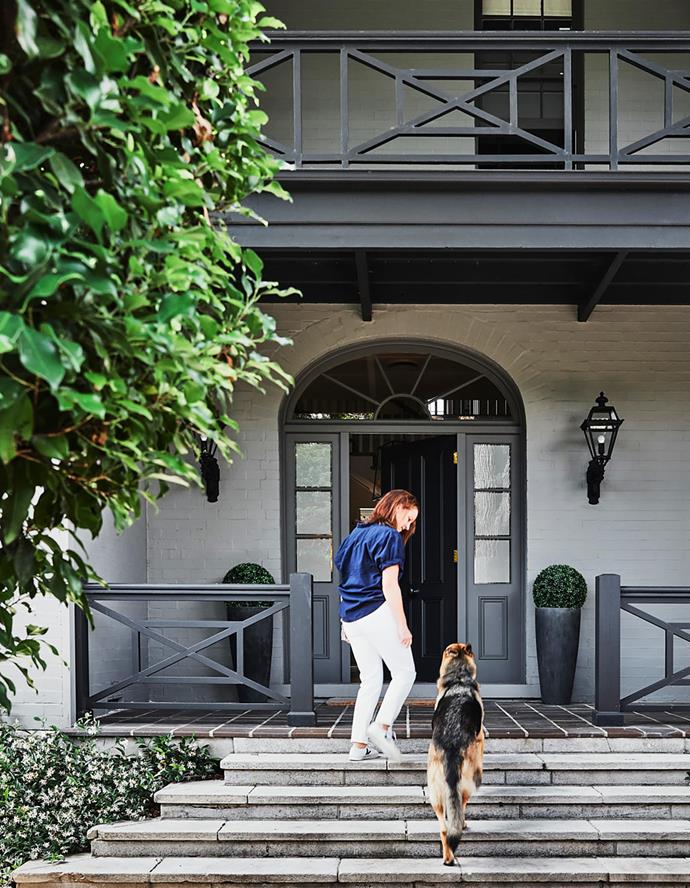 Homeowner Andrea Stark with German shepherd Rocco. The front garden was designed by Will Dangar.