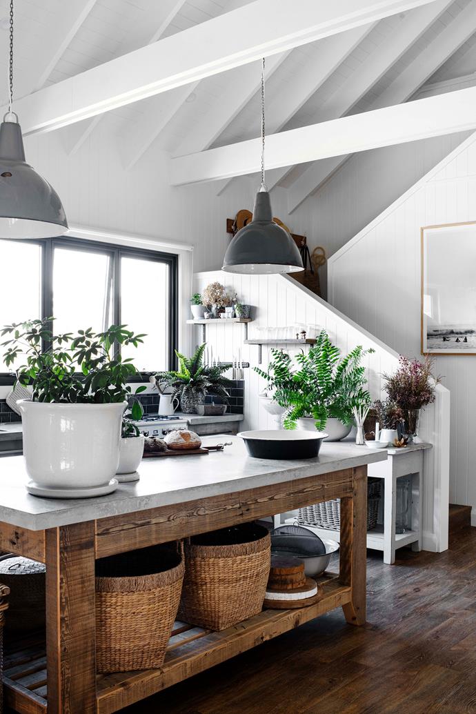 In a kitchen with soaring high ceilings, large statement pendants can work wonders. At a [new build on Lake Conjola](https://www.homestolove.com.au/modern-barn-style-house-19961|target="_blank"), two industrial style pendants salvaged from an old factory (purchased by the owners at [Haven & Space](https://havenandspace.com.au/|target="_blank"|rel="nofollow")) echo the strength and shade of the concrete benchtop below.