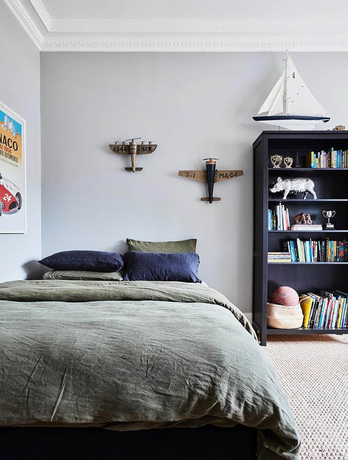 Rich tones of green and black complement Luke's fine collection of fun objects. Blue pillowcases, Città. Bookcase, Ikea. Smart buy: Flax linen bedding in Olive, $270/queen size, Bed Threads.