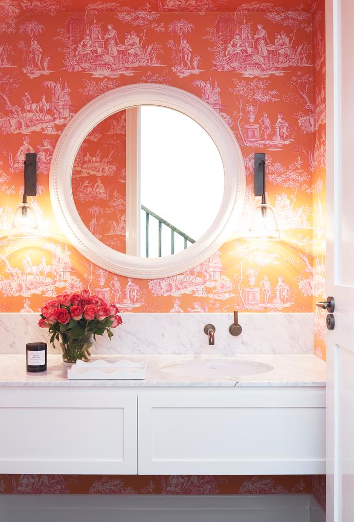 As this bathroom is small and has a low ceiling, Designer Alexandra Brownlow used the beautiful Manuel Canovas 'Balleroy' wallpaper on the walls and ceiling for warmth and to draw people into the space. *Photograph*: Christine Francis. From *Belle* April 2018.