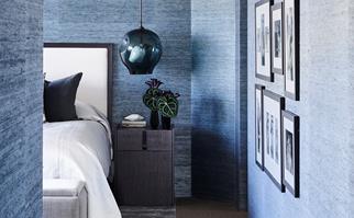 blue grasscloth wallpaper in a master bedroom