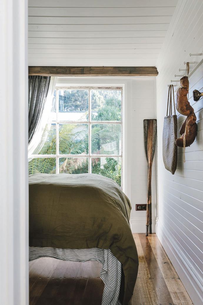 The bedroom, like the rest of the cottage, has been painted white and features polished Tasmanian oak floors.