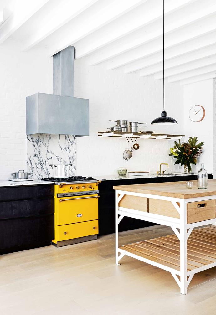 **Here comes the sun** In this kitchen, the moody hues of the black custom cabinetry are punctuated by a sunny yellow Lacanche 'Cormatin' cooker from Malcolm St James. *Project builder: [PMD Build](http://pmdbuild.com.au/|target="_blank"|rel="nofollow") | Styling: Claire Delmar | Photography: Felix Forest | Cabinetry design: [Meacham Nockles McQualter](https://www.meachamnockles.com/|target="_blank"|rel="nofollow"). Arabescato marble splashback and benchtop, [RMS Natural Stone & Ceramics](https://www.rmsmarble.com/|target="_blank"|rel="nofollow"). Island bench crafted by [Andrew Pinnock](http://www.andrewpinnock.com.au/|target="_blank"|rel="nofollow")*.