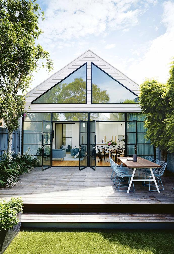 When Todd and Rachael bought the Port Melbourne property in 2006, they knew it had potential. A freestanding Victorian-era house with a more recent extension at the back, it had a [pretty facade](https://www.homestolove.com.au/fabulous-facades-18972|target="_blank") and was positioned on a large corner block close to the city and the seaside. "We're at the beach in five minutes," says Rachael. "It takes about 15 minutes to walk to South Melbourne markets and we're so close to the city."<br><br>**Exterior** Owners Rachael and Todd committed to a wall of black steel-framed windows and doors.