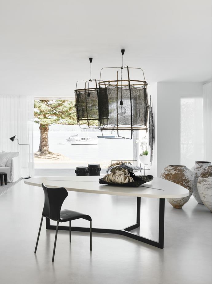 This page 'Z11' cashmere pendant lights by Ay Illuminate. Interior designer Pamela Makin placed a cluster of Turkish urns to add texture to the dining space and contrast with the clean contemporary lines of the B&B Italia 'Seven' dining table. B&B Italia 'Papilio' leather dining chair from Space.