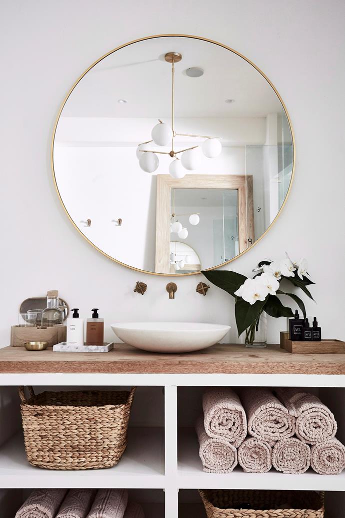 Create a spa-like feel in your bathroom with fresh flowers, candles, soaps and hand creams on display. *Photo:* Kristina Soljo / *bauersyndication.com.au*