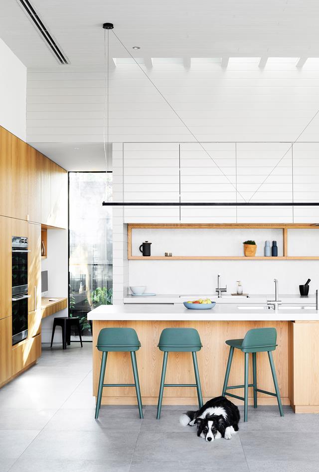[This pared-back kitchen](https://www.homestolove.com.au/a-melbourne-home-with-a-stable-inspired-interior-6274|target="_blank") features a concealed pantry and study nook which are both illuminated by a skylight.