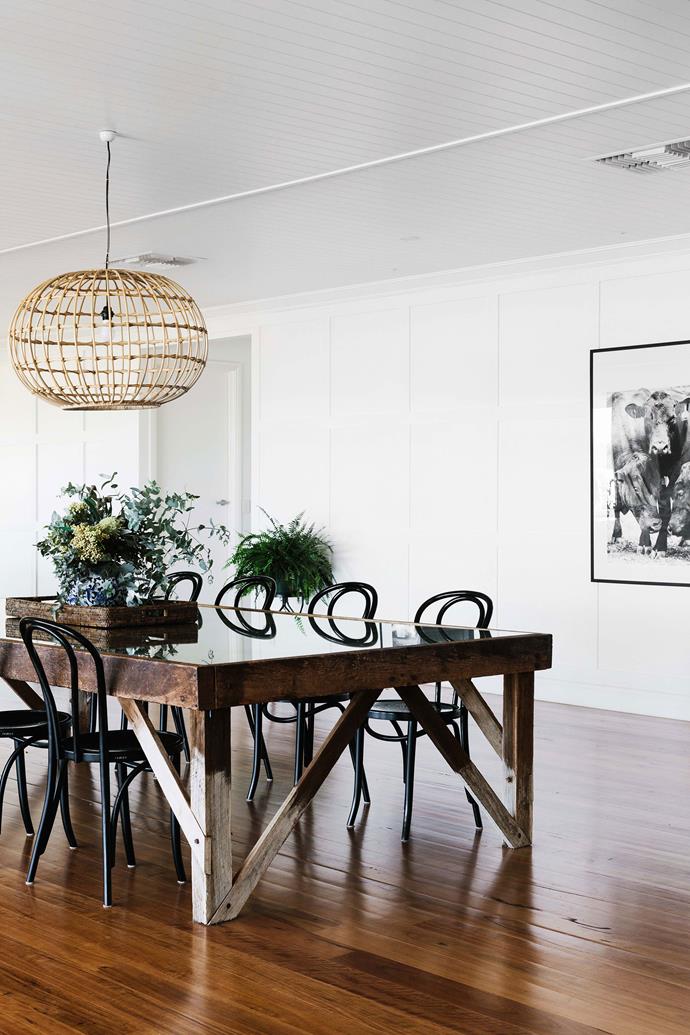 A cane pendant light from [St Barts](https://st-barts.com.au/|target="_blank"|rel="nofollow") hangs above a wool classing table, which was found in the shearing shed at the family's other property Evergreen, near Talwood.