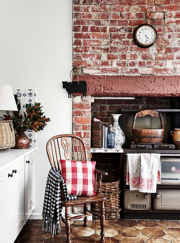 The kitchen's existing red-brick hearth and tiled splashback were maintained during the renovations.