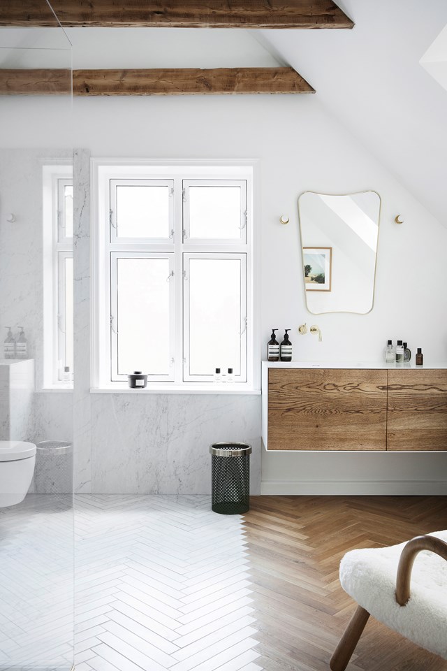 The subtle genius of combining marble and timber herringbone flooring makes [this fashion stylist's charming villa bathroom](https://www.homestolove.com.au/pernille-teisbaek-home-tour-copenhagen-20173|target="_blank") something quite special.