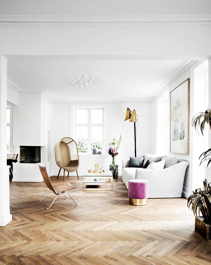 Pernille's love of Scandi brands is evident throughout her home. Also in the living area are a leather chair by Poul Kjærholm (a family heirloom) and Cocoon chair by Danish duo Kevin Hviid and Martin Kechayas. A FOS floor lamp stands in one corner while a sleek fireplace connects the living and dining areas.