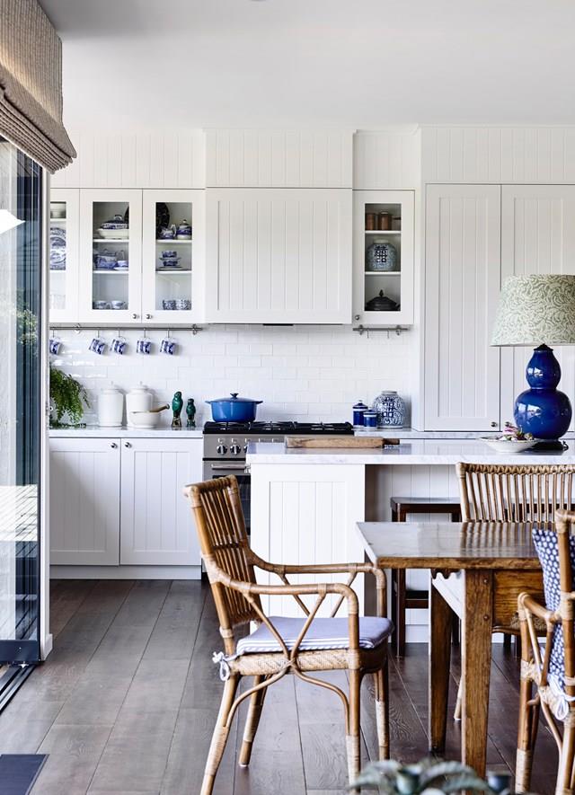 A favourite dinner set displayed behind glass contributes to the [warmth of this provincial-style kitchen](https://www.homestolove.com.au/10-steps-to-coastal-style-4398|target="_blank"). "The owner was specific about having glass-fronted cabinetry," says designer Adelaide Bragg. "It adds charm and softens the kitchen, and makes it part of the open plan." And, unlike open shelving, these cabinets don't gather dust. *Photograph*: Derek Swalwell | *Styling*: Tess Newman-Morris