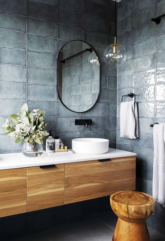 **Little mix** <br><br>It's not always easy to create that coveted lived-in feeling in a new build, but the texture-rich bathroom of the Denman Prospect Residence in Canberra's Molonglo Valley has it in spades. <br><br>Designed by [Studio Black Interiors](https://www.studioblack.com.au/|target="_blank"|rel="nofollow"), the ensuite effortlessly and dramatically combines the blue-green glazed porcelain Iris Aguamarina wall tiles from [Rivoland Tiles](https://rivoland.com.au/|target="_blank"|rel="nofollow") with warm timber and accents of black and brass. A crisp-white stone vanity top provides just the right amount of visual breathing space. <br><br>Executed with subtlety, the small room mixes materials and textures in a shining example of how a little bit of daring can go a long way. <br><br>