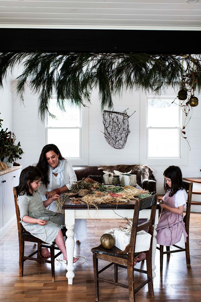 She-oak acts as a canopy above Arkie, Brooke and Ruby as they weave coasters using raffia and plant fibres. The table was a gift from Colin's godfather.