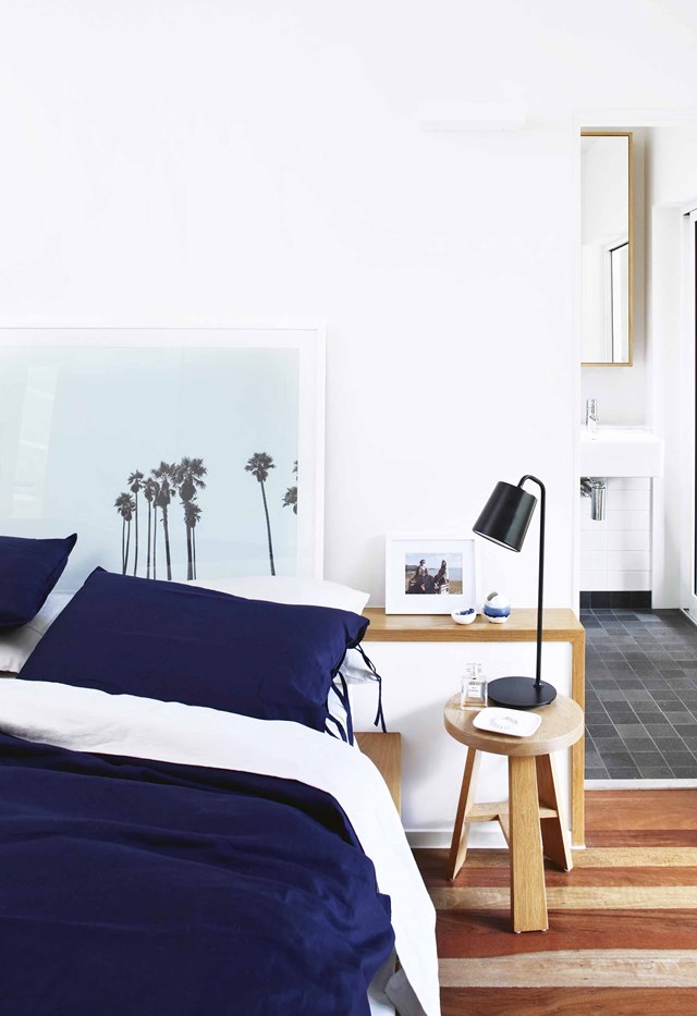A simple bedside [table lamp](https://www.homestolove.com.au/table-lamps-australia-21266|target="_blank") solves the problem of no task lighting in this bedroom, while the framed print sits nicely on the bedhead - no hanging necessary.