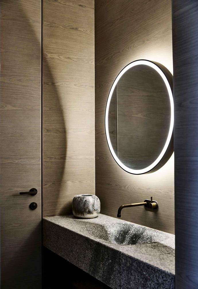 An **LED-lit circular mirror** brings Hollywood glam to a Melbourne bathroom by [B.E Architecture](https://www.bearchitecture.com/|target="_blank"|rel="nofollow").