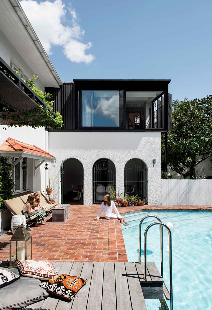 The red bricks lining the pool area create a striking contrast.